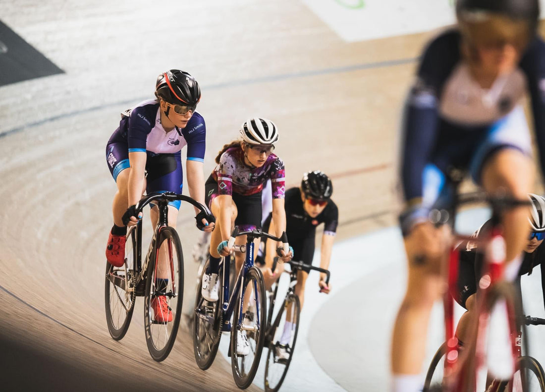 Junior track cyclist racing on an indoor wooden velodrome 