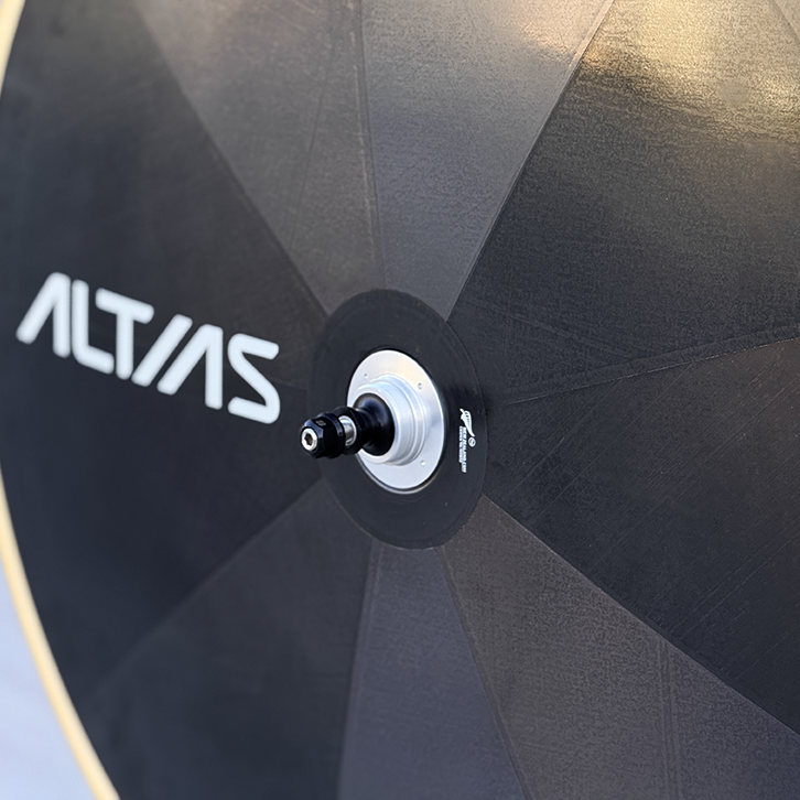 Close-up of a bicycle wheel with 'Altias' branding on a light blue background
