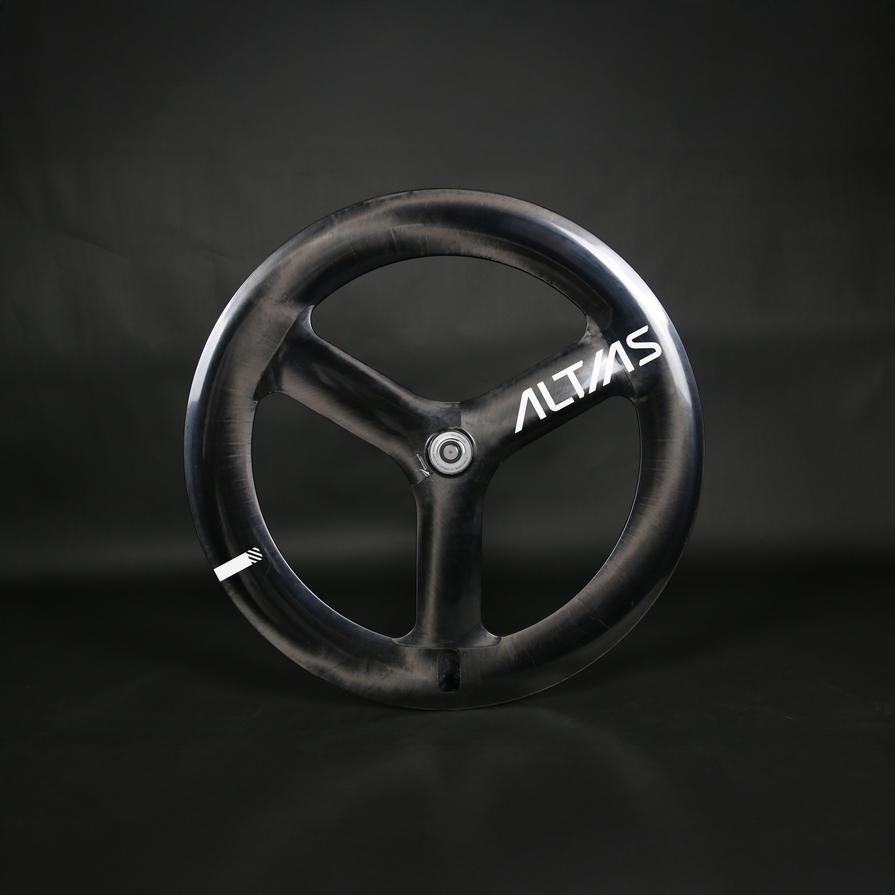 Black tri spoke track cycling wheel with 'ALTIAS' branding on a dark background